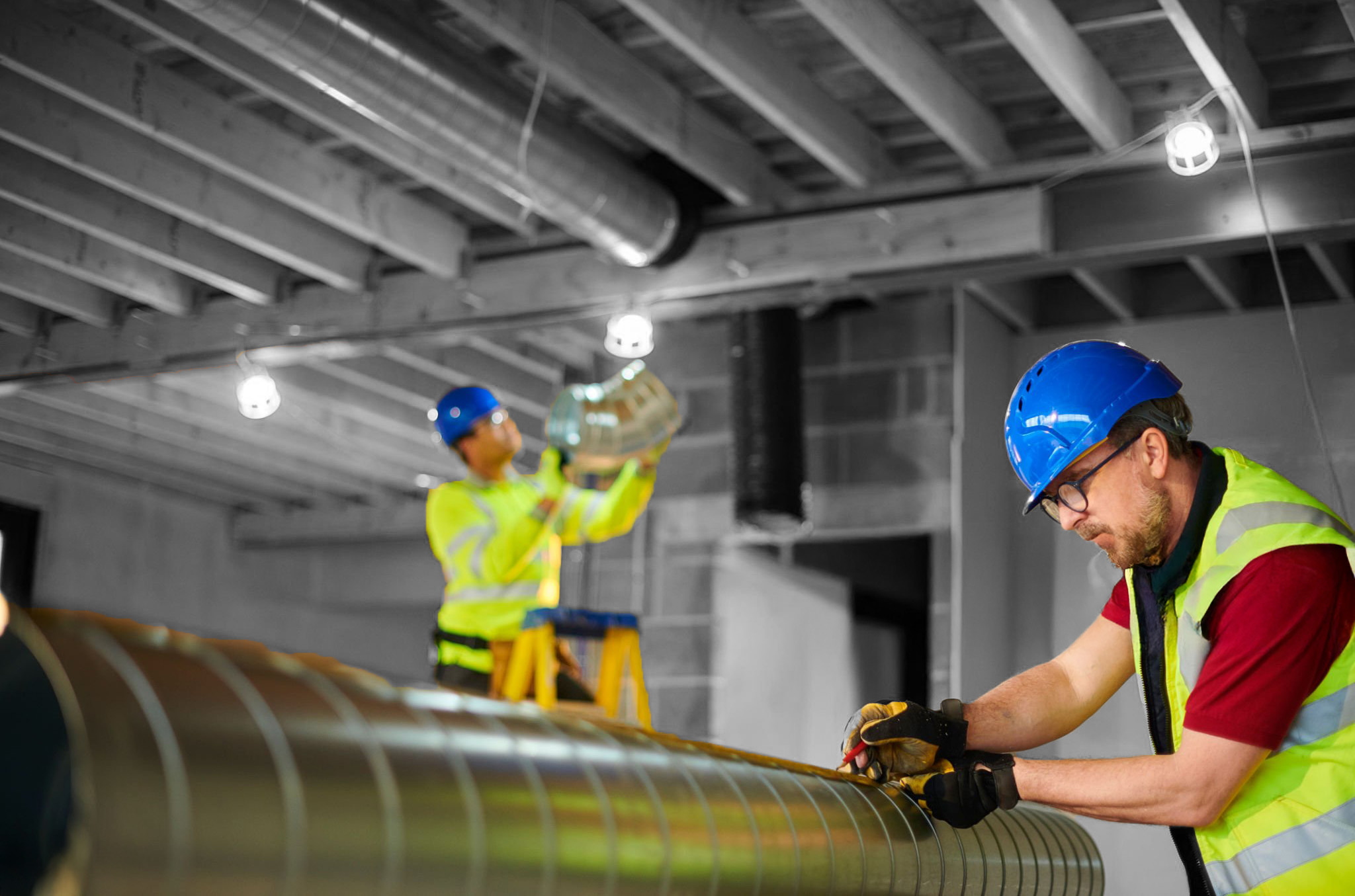 Third Coast Mechanical workers test fitting prefabricated ducts for precise commercial HVAC installation.